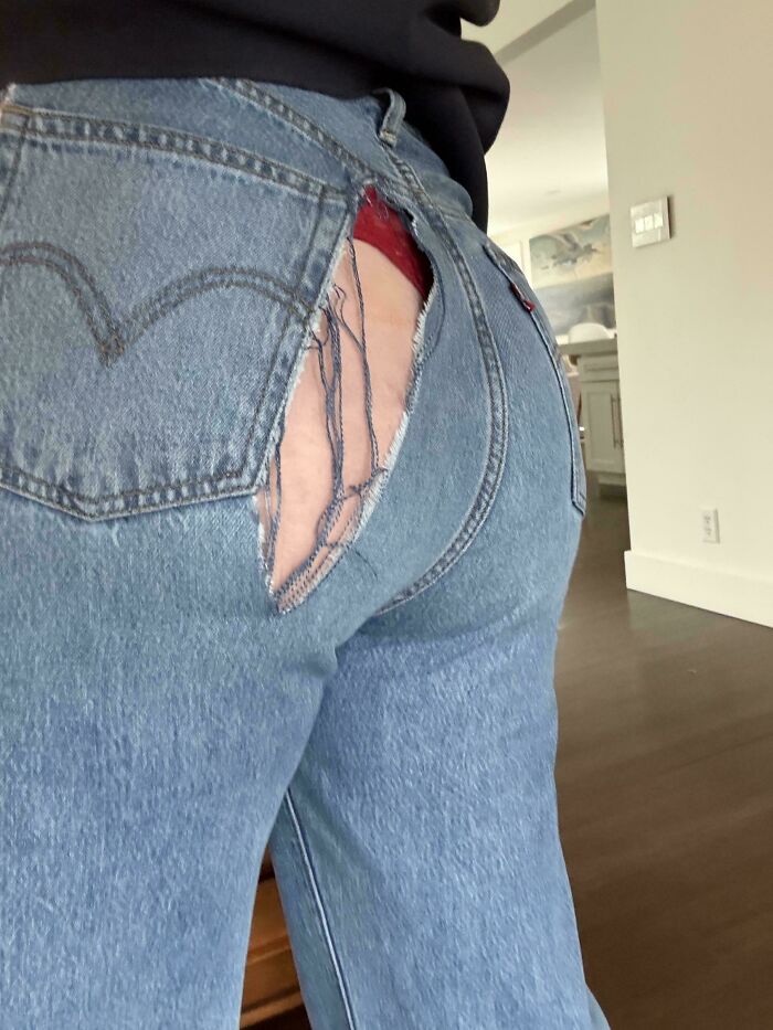 A person wearing ripped jeans revealing red underwear, a cringy fail.