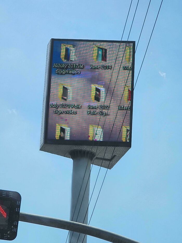 A large outdoor digital display showing multiple small images of doors, a cringy fail.