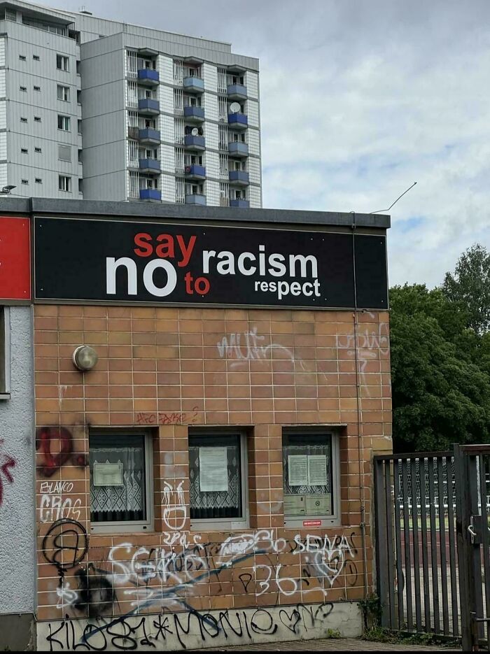 A building with a sign that says say no to racism respect, a cringy fail.