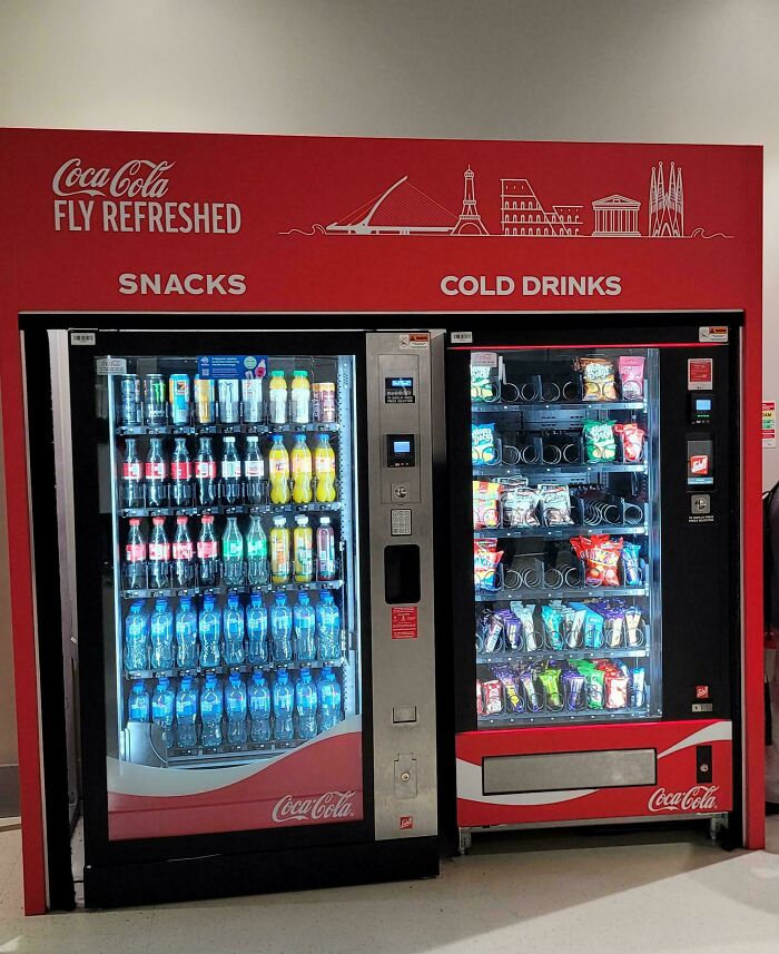 A Coca-Cola vending machine at the airport offering snacks and cold drinks, a hilarious thing spotted at airports.