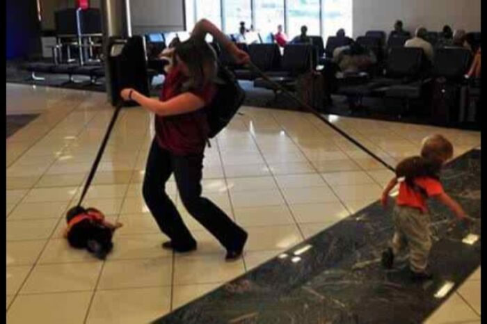 A woman pulls a toddler and a small dog on leashes through an airport, a weird thing spotted at airports.