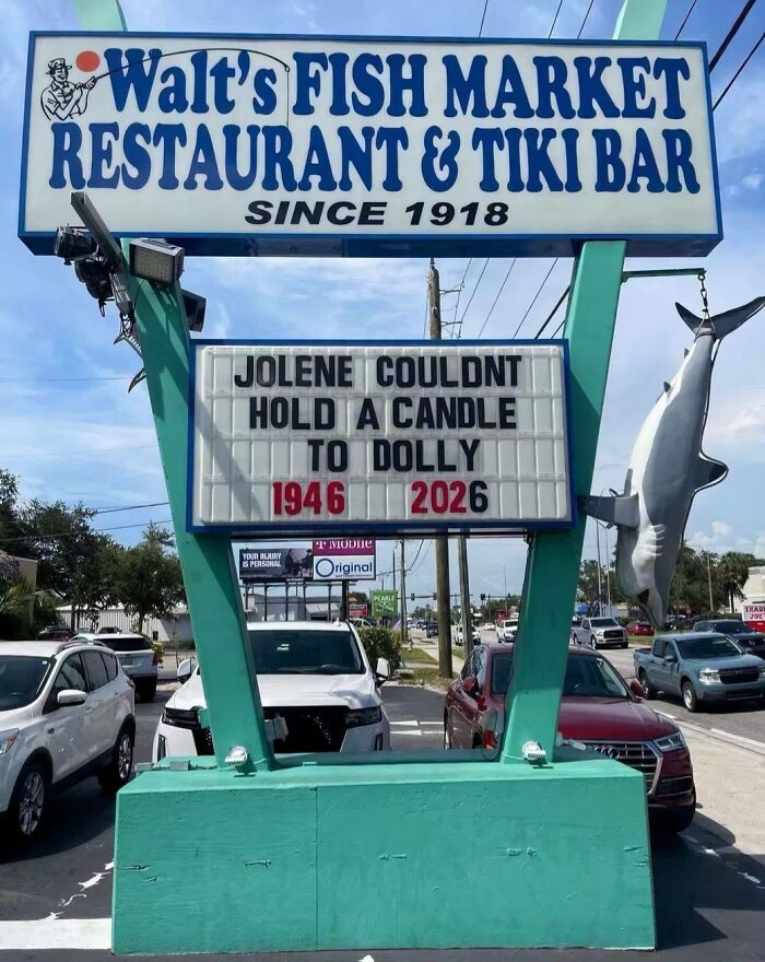 A restaurant sign with funny signs stating 'Jolene couldnt hold a candle to Dolly 1946-2026'.