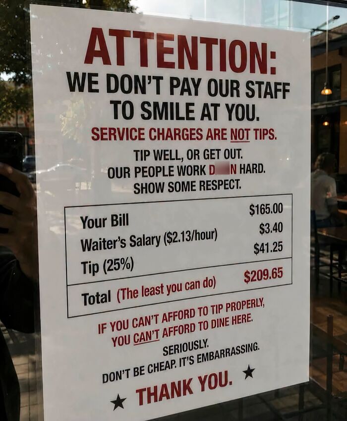 A funny sign with the title ATTENTION: and text below explaining service charges and tips.