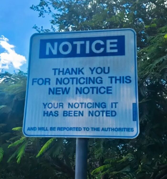 A funny sign post with a notice thanking for noticing this new notice.