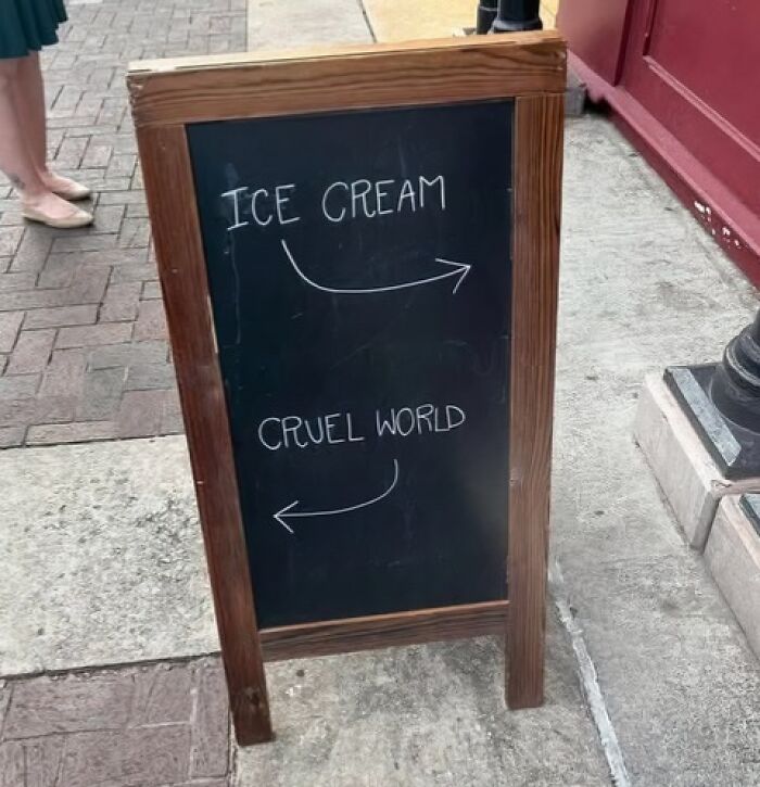 A silly funny sign for ice cream or a cruel world, a humorous choice on a chalkboard.
