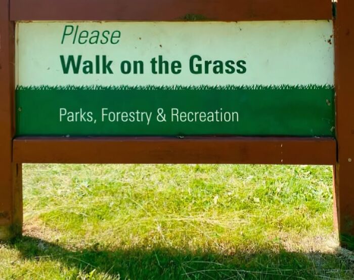 A funny sign that reads Please Walk on the Grass from Parks, Forestry & Recreation.