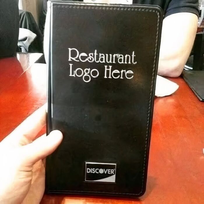 A silly funny sign on a restaurant check presenter that says Restaurant Logo Here.