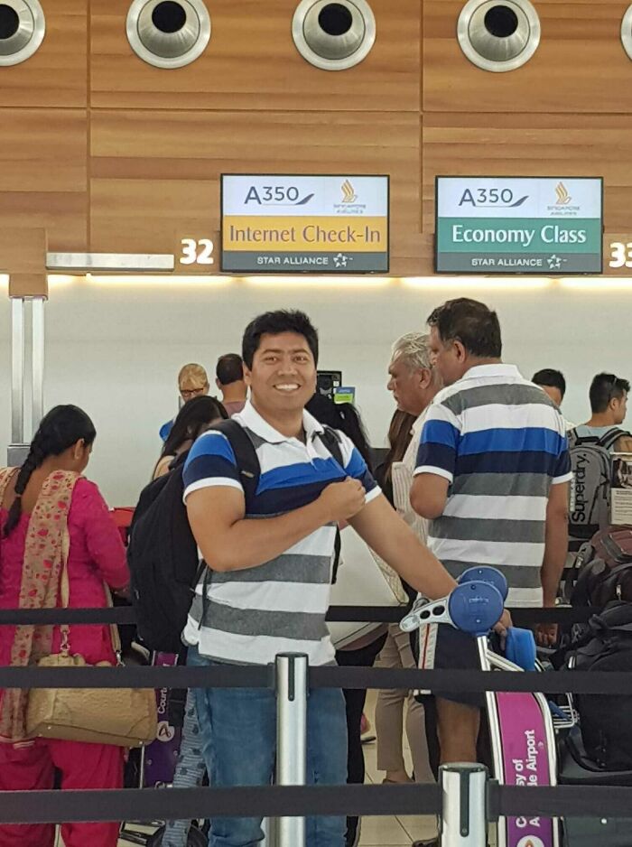 Happy traveler poses at airport check-in, among other things spotted at airports, showing a funny moment.