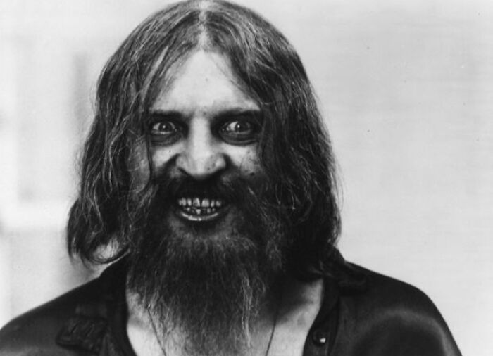 Unsettling pictures of a man with long hair and a beard, staring intensely with a menacing grin.