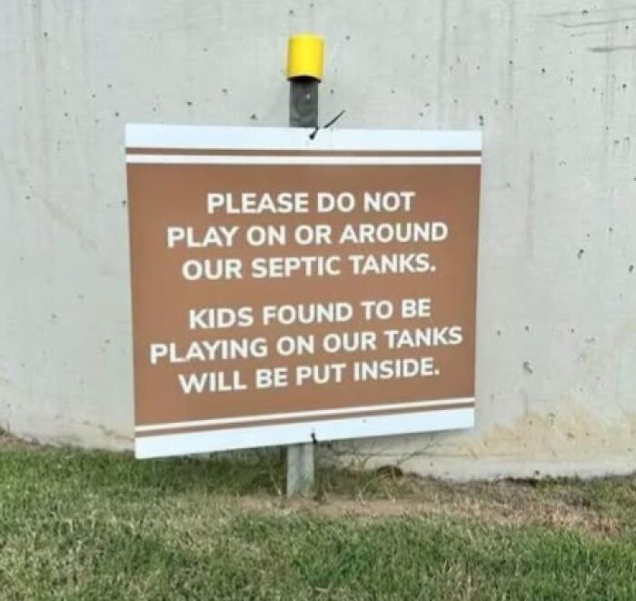 A silly sign warning kids not to play on septic tanks, or they will be put inside.