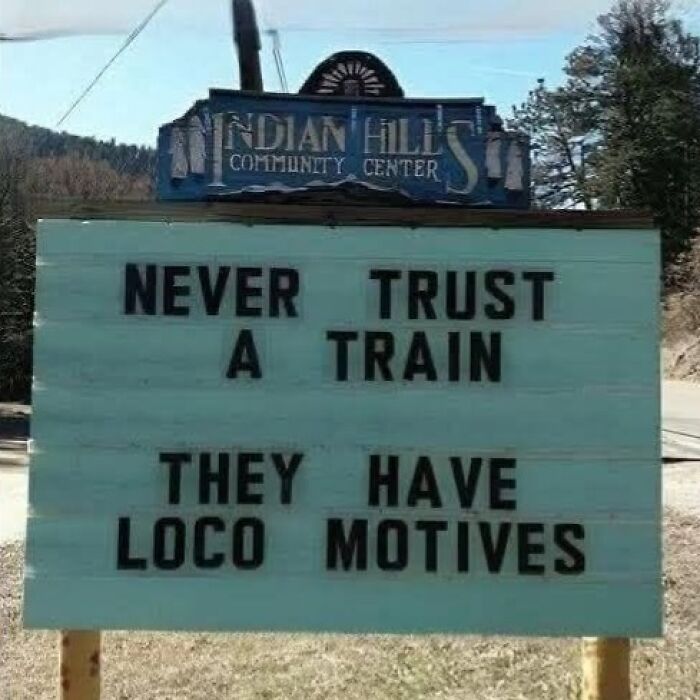 A funny sign outside Indian Hills Community Center with the text Never Trust a Train They Have Loco Motives.