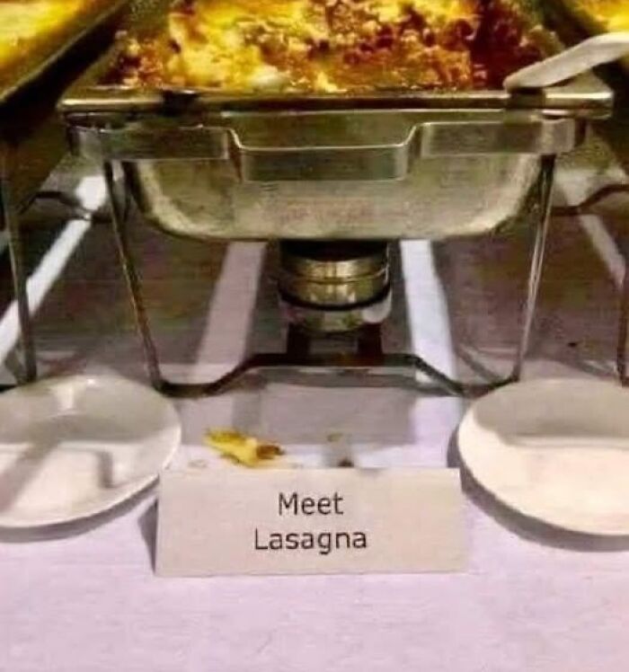 A catering dish with a silly-funny sign that says Meet Lasagna.