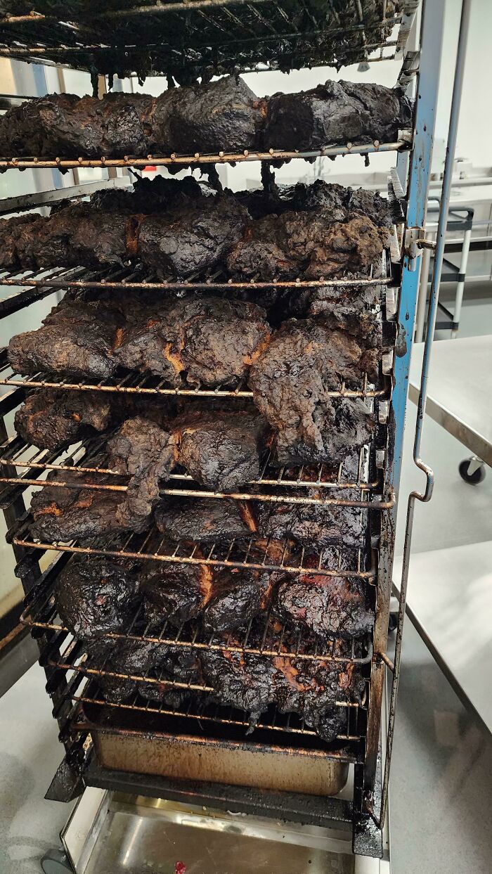 Multiple racks of severely burnt, black food items, a clear example of kitchen fails.