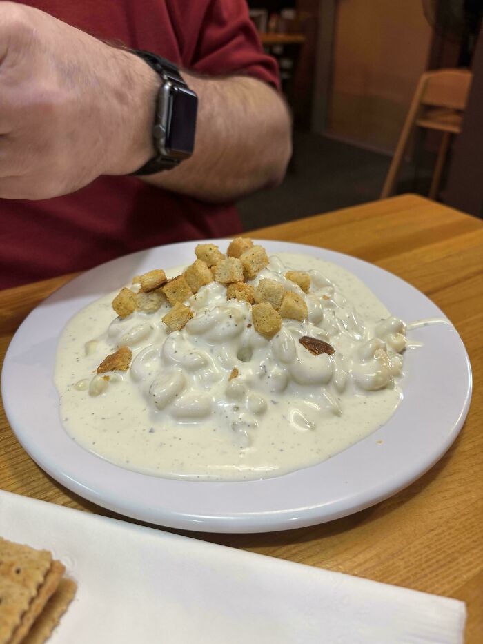 A plate of macaroni and cheese with croutons, appearing like a strange kitchen fail.