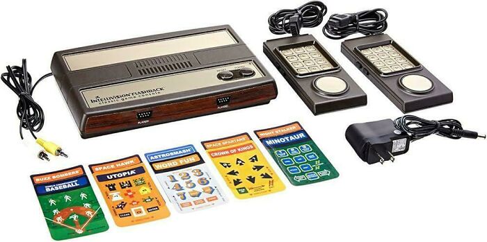 A complete set of Intellivision Flashback classic game console with controllers and game overlays, showcasing 80s retro tech.