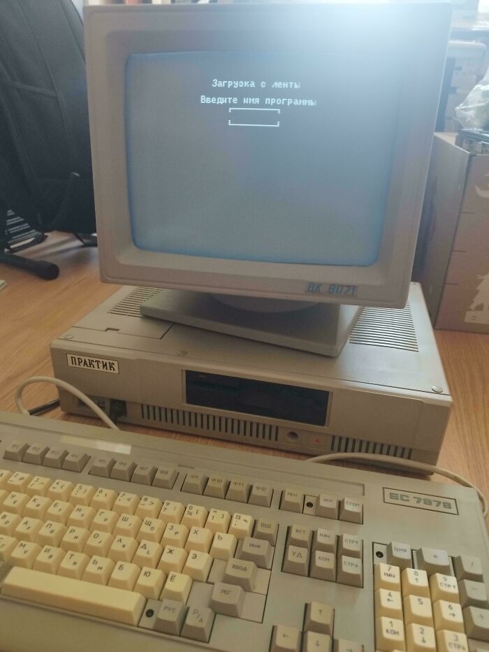 Retro tech photo displaying an 80s computer setup with a monitor and keyboard.