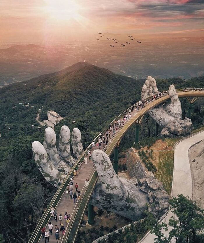 Stunning street art bridge held by giant hands, proving streets are real museums.