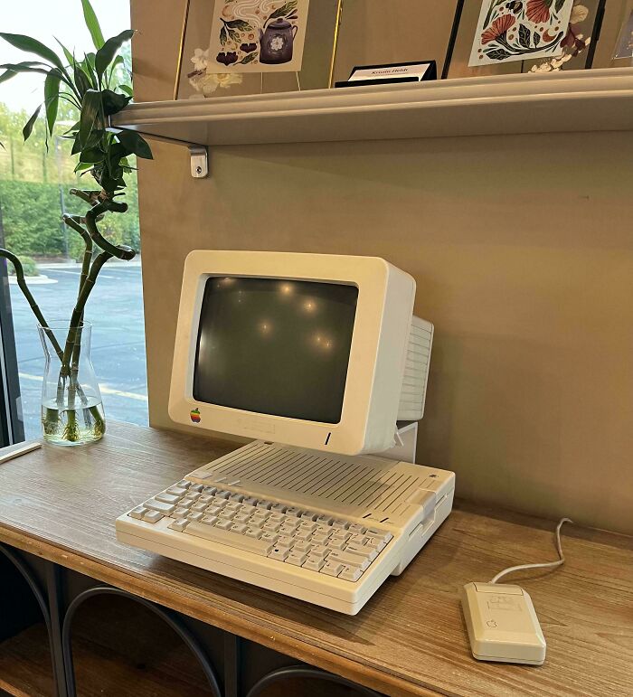 A classic Apple retro tech computer setup from the '80s, including a monitor, keyboard, and mouse.