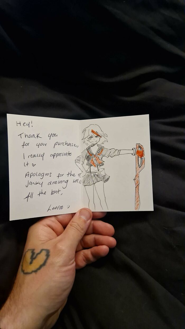 Hand holding a thank you note with a Vinted post drawing, showing unhinged Vinted posts.