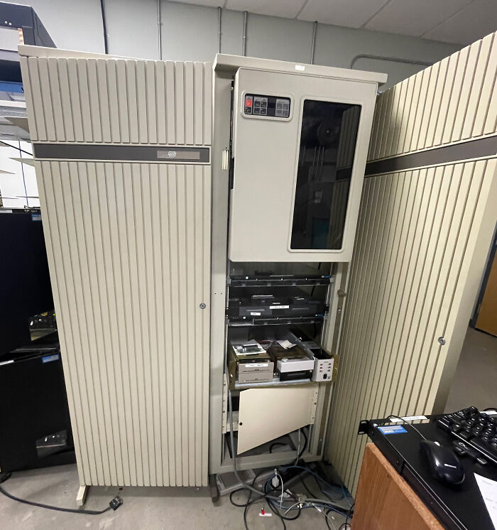 Large retro tech computer mainframe with open panels, showcasing 80s glorious and weird technology.