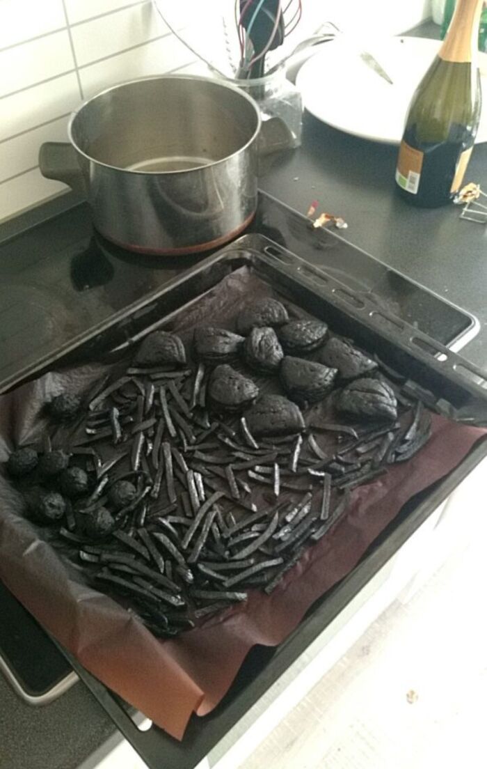 A baking sheet with completely burnt, black food, exemplifying an extreme kitchen fail.