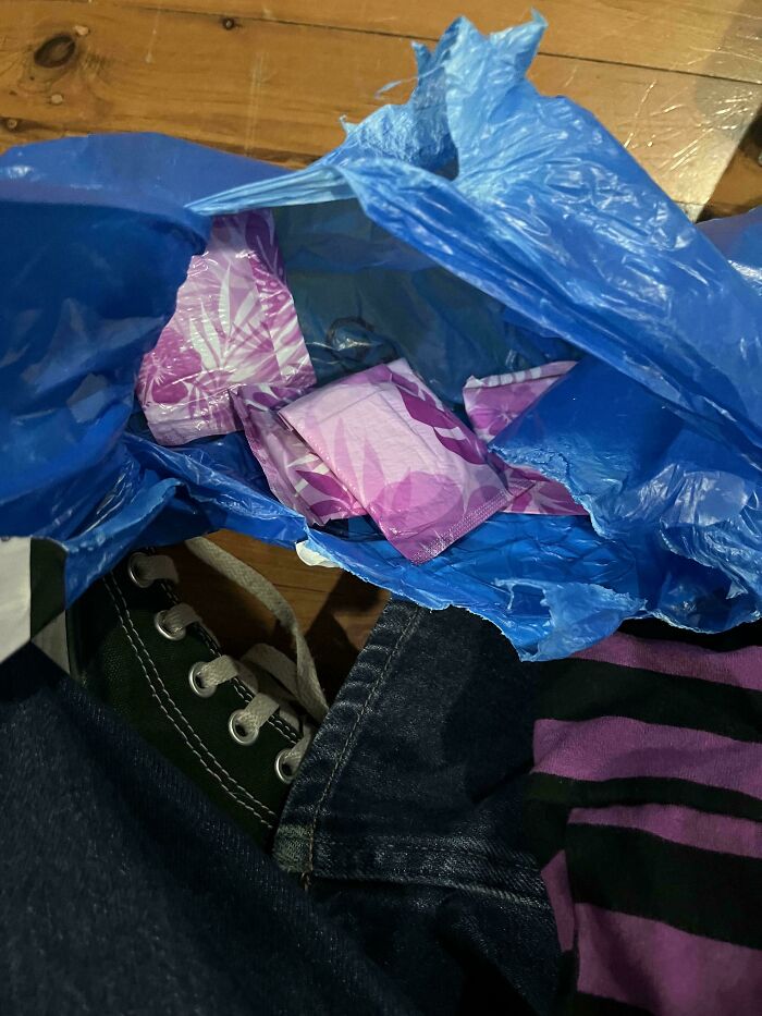 A blue plastic bag filled with feminine hygiene products, part of unhinged Vinted posts.