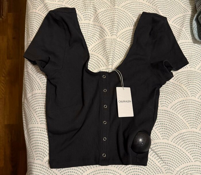 A black Calvin Klein top with a tag, part of unhinged Vinted posts.
