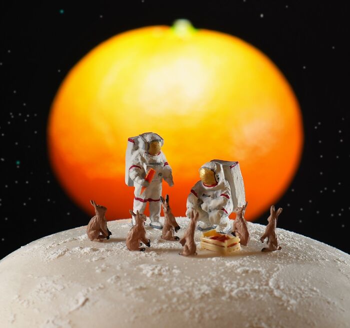 Miniature Calendar work by Tatsuya Tanaka featuring astronauts and rabbits on a moon-like surface with a bright orange sun.