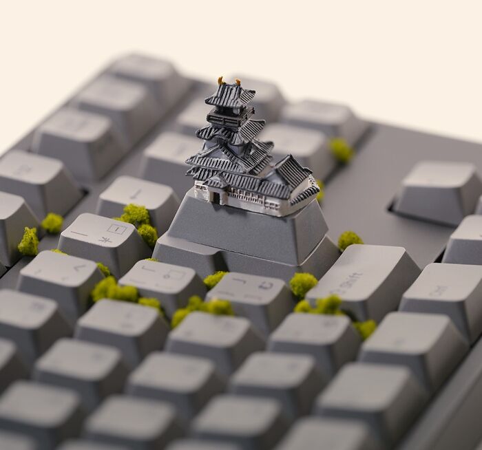 A miniature calendar work by Tatsuya Tanaka featuring a tiny castle on a keyboard, resembling a landscape.