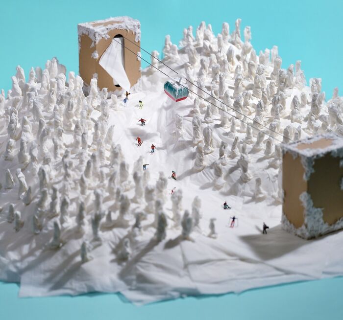 Tatsuya Tanaka miniature calendar work: Miniature skiers on a snowy mountain made from tissues with tissue box buildings.