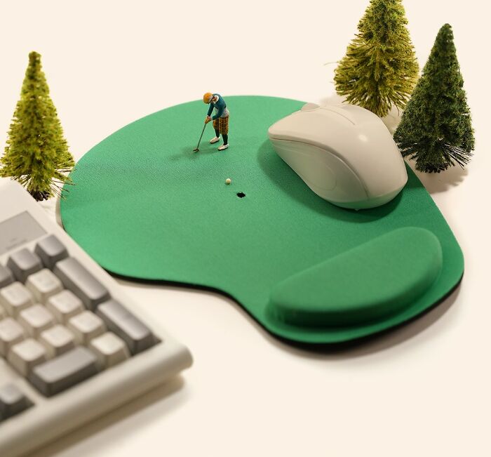 Miniature Calendar work by Tatsuya Tanaka featuring a tiny golfer on a mouse pad green.