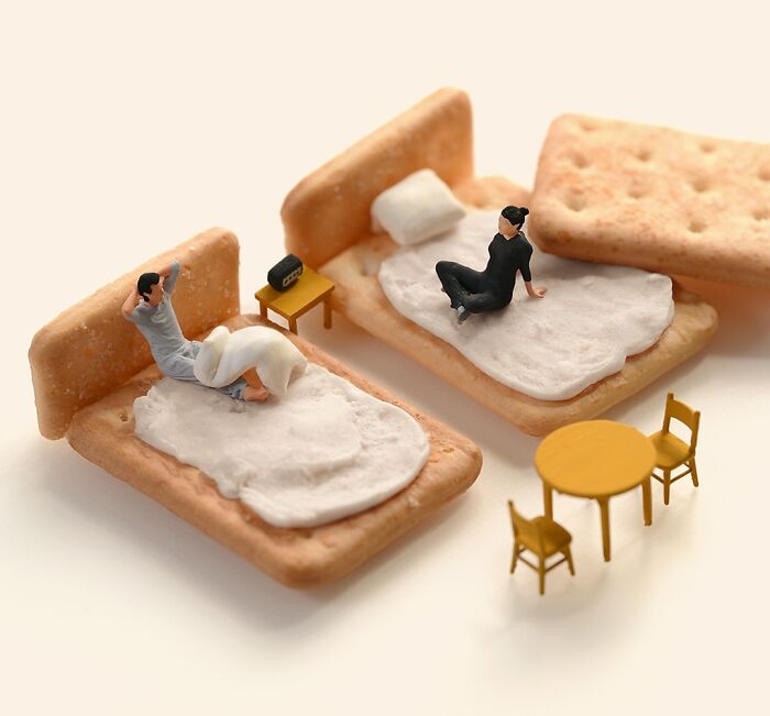 Miniature calendar scene by Tatsuya Tanaka with figures on cracker beds and a small table.