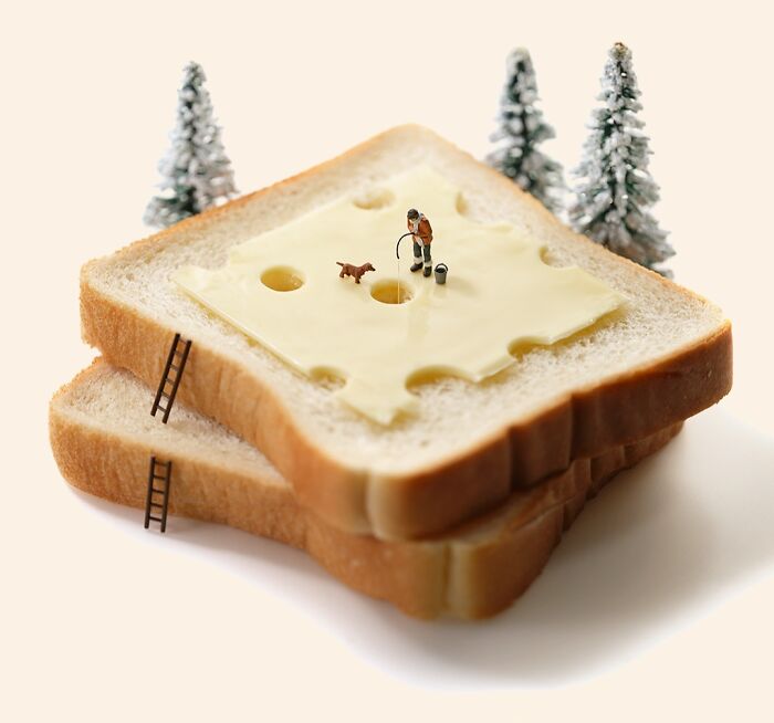 A miniature calendar work by Tatsuya Tanaka showing a person fishing in a slice of cheese on bread.