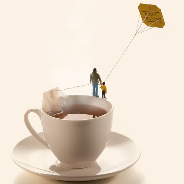 A miniature calendar work by Tatsuya Tanaka, depicting tiny figures flying a teabag kite over a teacup.