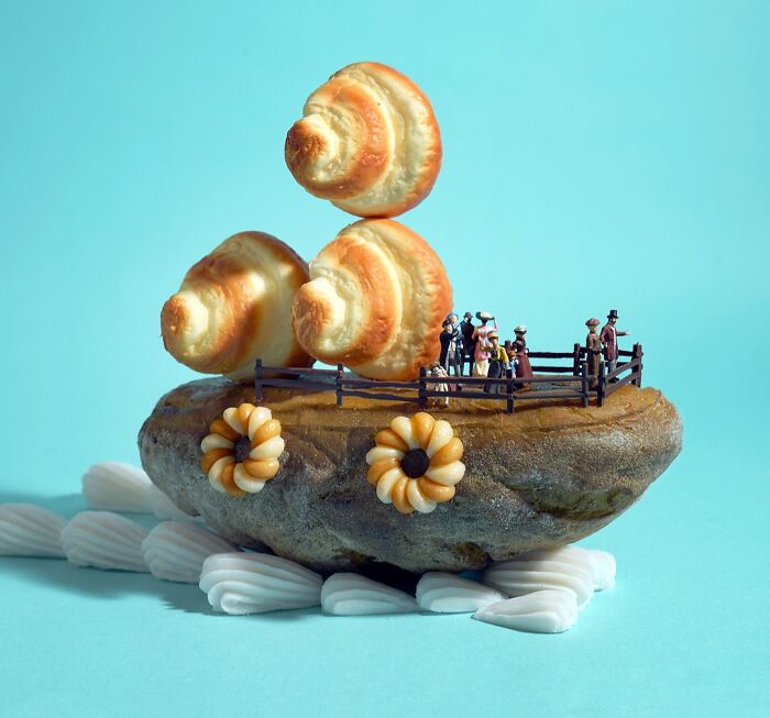 Miniature Calendar work by Tatsuya Tanaka with tiny people on a potato island, under croissant sails.