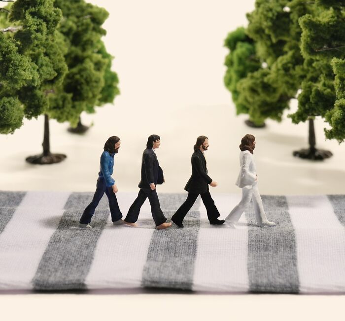 Miniature calendar scene by Tatsuya Tanaka of figures crossing a striped fabric road like the Beatles.