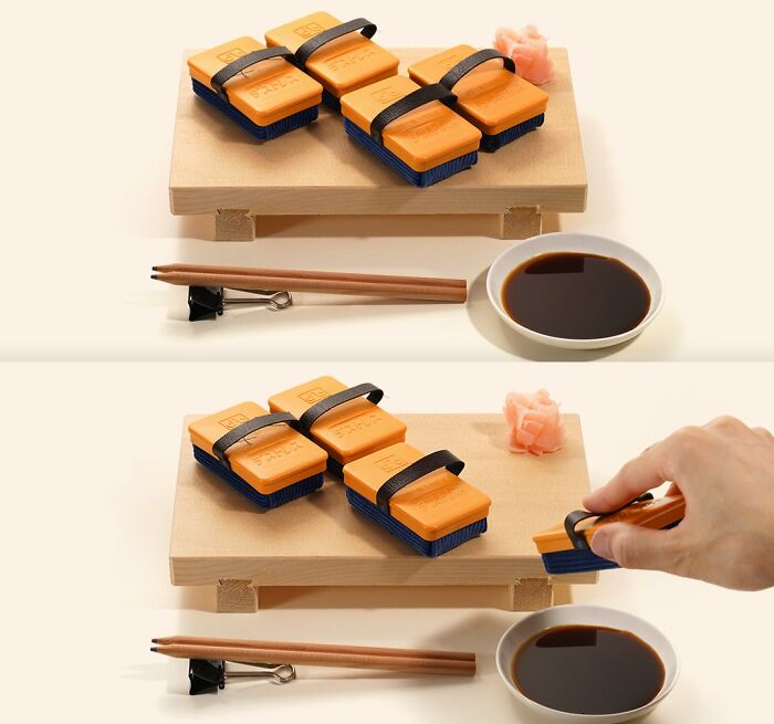 Miniature Calendar Works by Tatsuya Tanaka featuring sushi-shaped staplers on a wooden board with soy sauce and chopsticks.