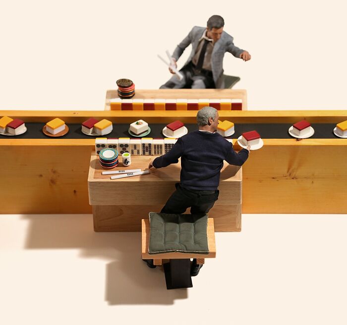 Miniature calendar works by Tatsuya Tanaka: tiny figures on a sushi conveyor belt made from office supplies.