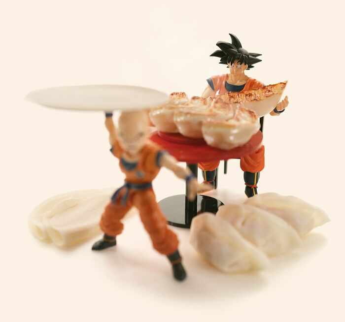 Miniature calendar works by Tatsuya Tanaka: Dragon Ball figures serving dumplings on a table made of food.
