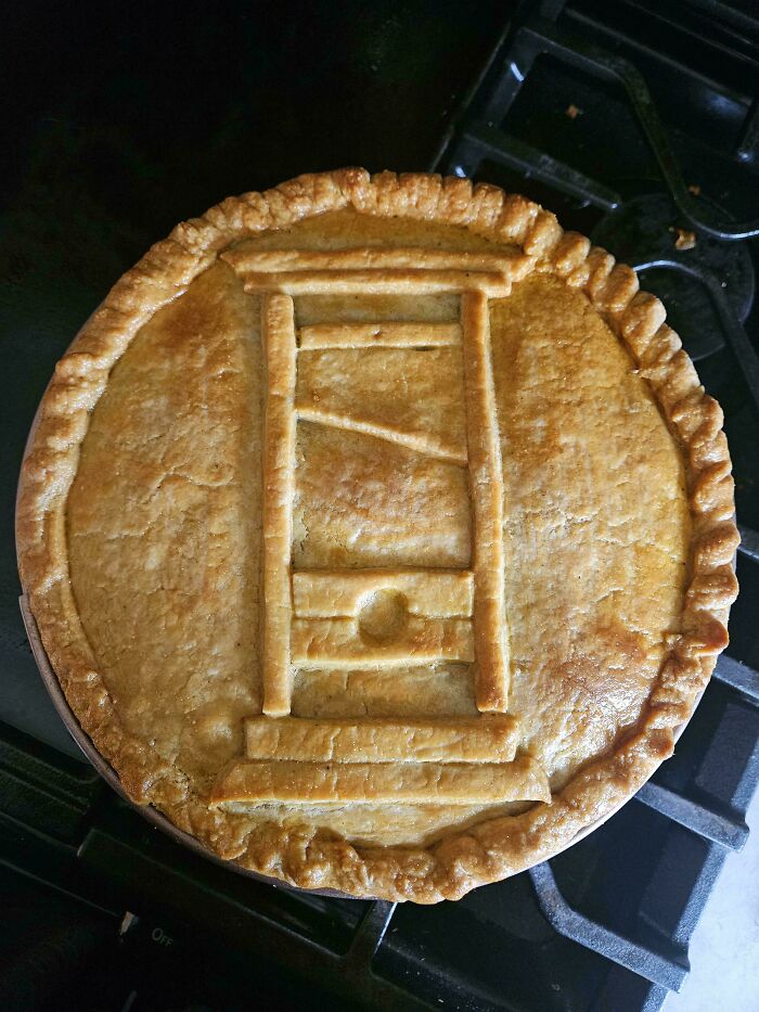 A pie with a guillotine design on top, representing Eat The Rich moments.