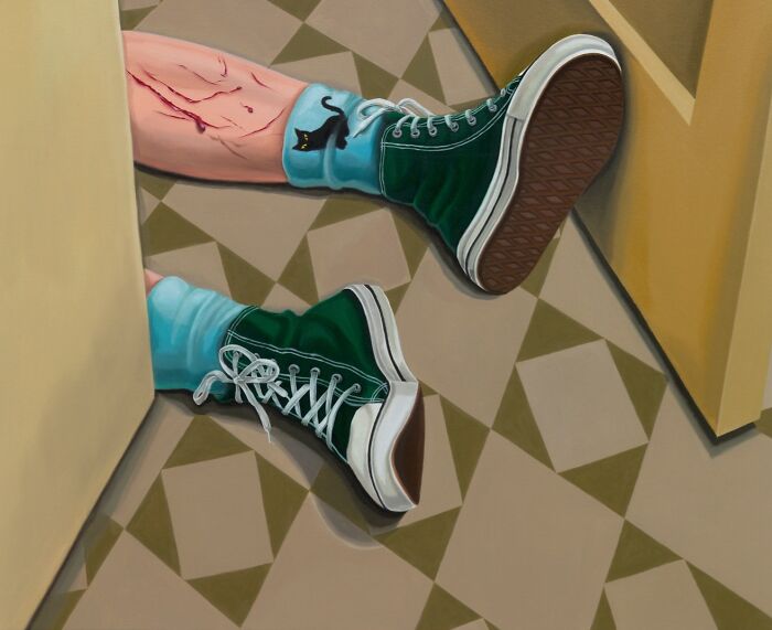 A pair of legs in green sneakers and socks with black cats visible, laying on a tiled floor, creating a surreal moment.