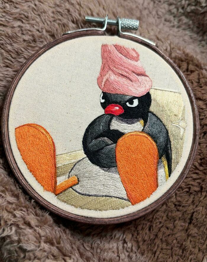 Embroidery projects showcasing Pingu wearing a pink towel on his head with a grumpy expression