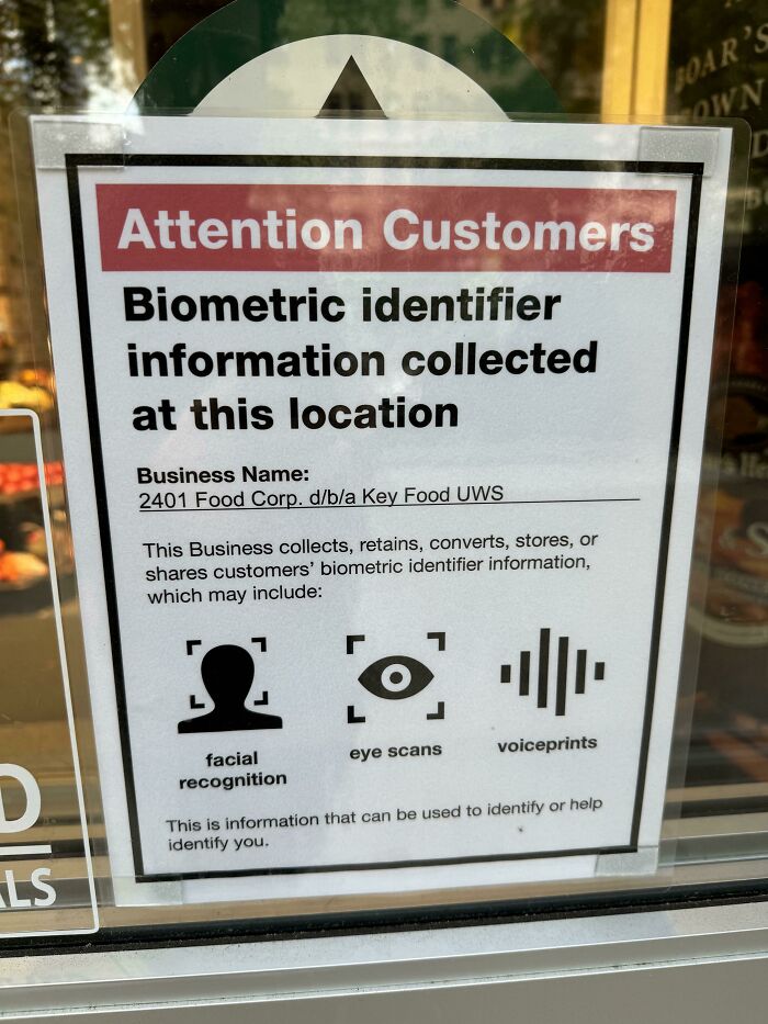 A close-up of a sign informing customers about biometric identifier information collected, reflecting a horrid and sad world.