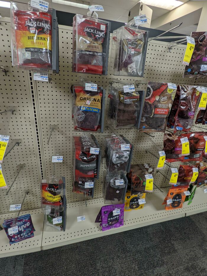 A nearly empty store shelf with few products left, reflecting a horrid and sad world.
