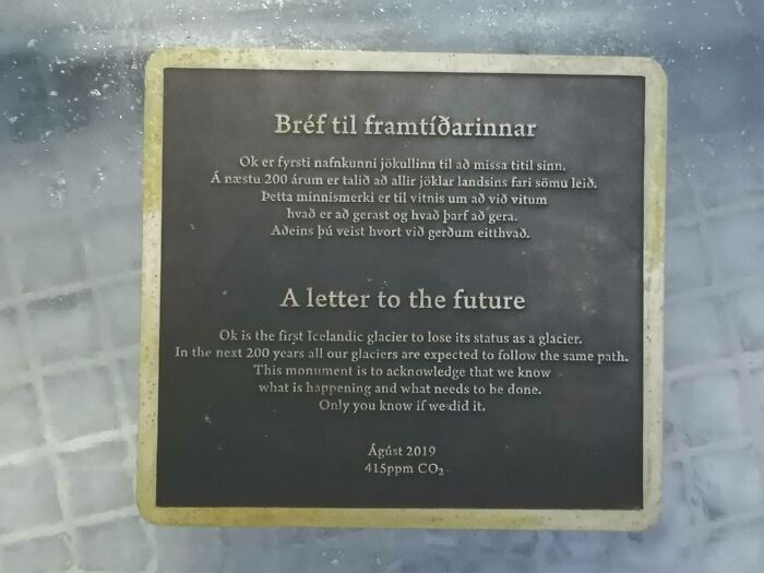 A memorial plaque, a letter to the future, on a melting glacier, highlighting the horrid and sad world of climate change.