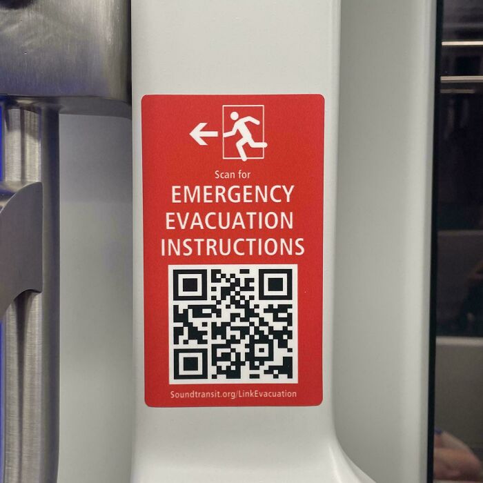 A red sticker with emergency evacuation instructions and a QR code, highlighting a sad world scenario.
