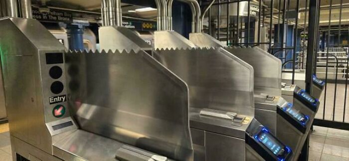 Subway turnstiles represent the horrid world, showing the daily commute and urban struggles.