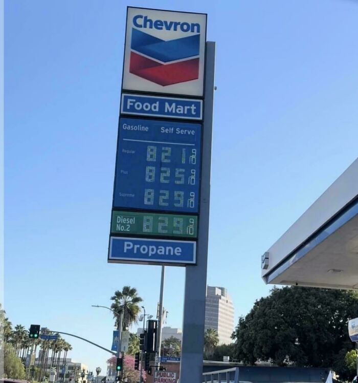 A Chevron sign displaying high gasoline prices at $8.21, reflecting the horrid and sad world of fuel costs.