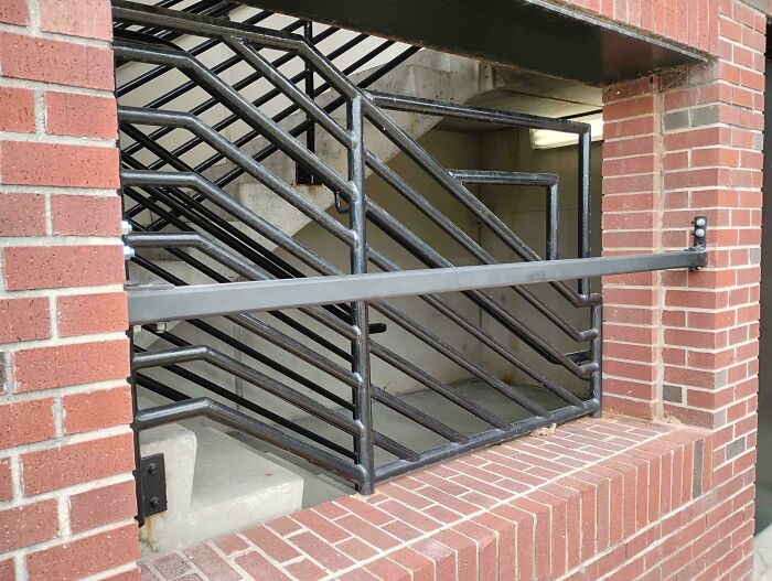A secured stairwell behind an iron gate, illustrating a horrid and sad world.