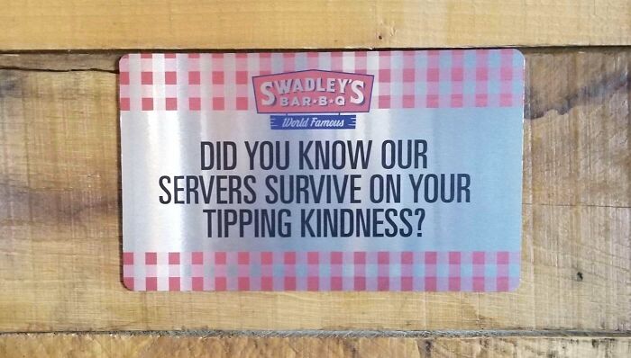 A sign at Swadley's BBQ about the horrid world we're living in, asking for tips for servers' survival.